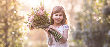 Communie - Meisje met bloemen en een feestelijk jurkje