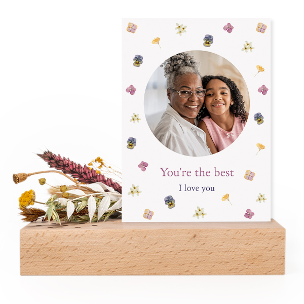 Forex card in wooden stand with dried flowers