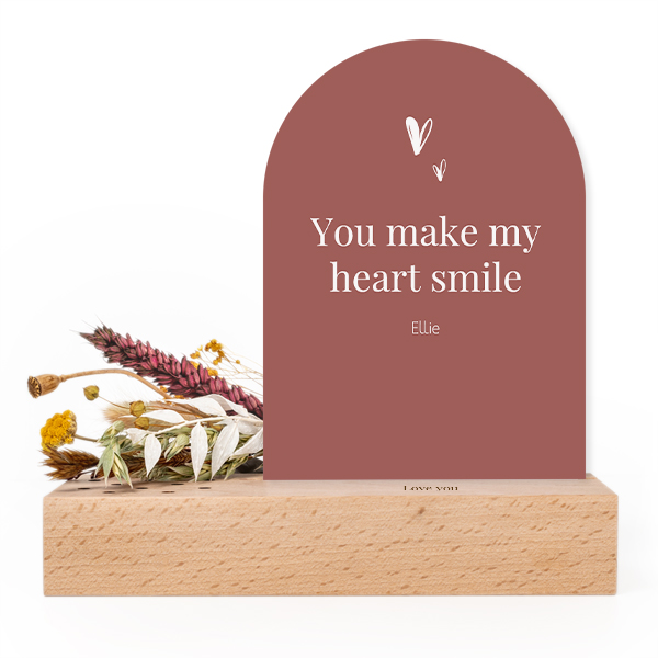 Wooden block with print, dried flowers and arched forex card
