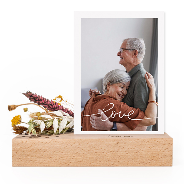 Wooden block with print, dried flowers and forex card