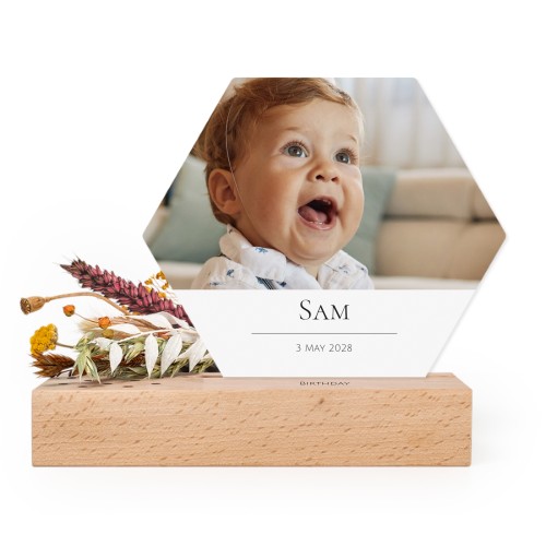 Wooden block with print, dried flowers and hexagonal forex card