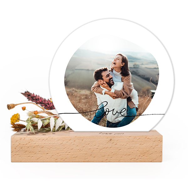 Wooden block with print, dried flowers and rounded forex card