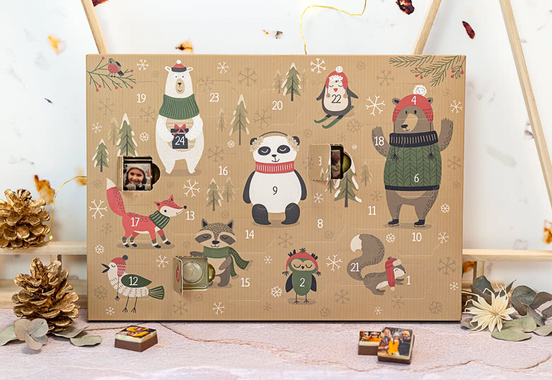 Personalised chocolate advent calendar with festive animal illustrations on a brown background. Features customisable photo windows.