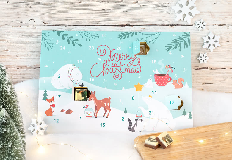 Personalised chocolate advent calendar with a light blue background, featuring festive animal illustrations and the text "Merry Christmas."