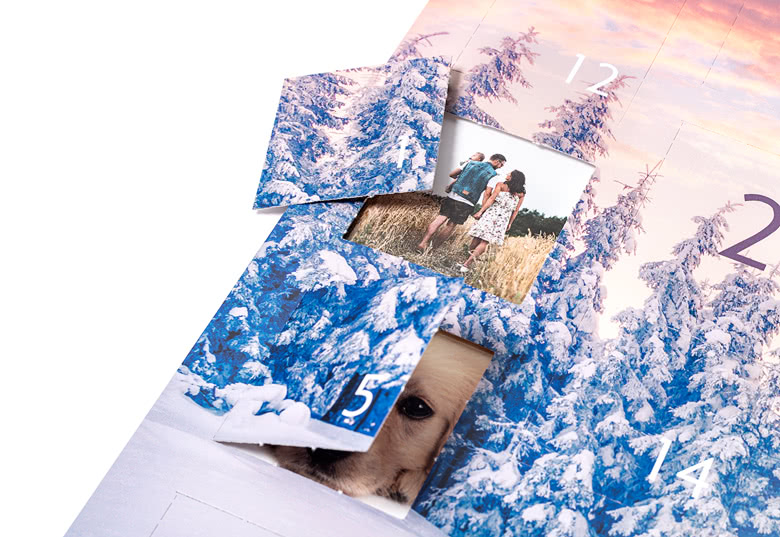 Photo advent calendar with snowy blue and white tree design, featuring personalised photo windows revealing family and pet images.