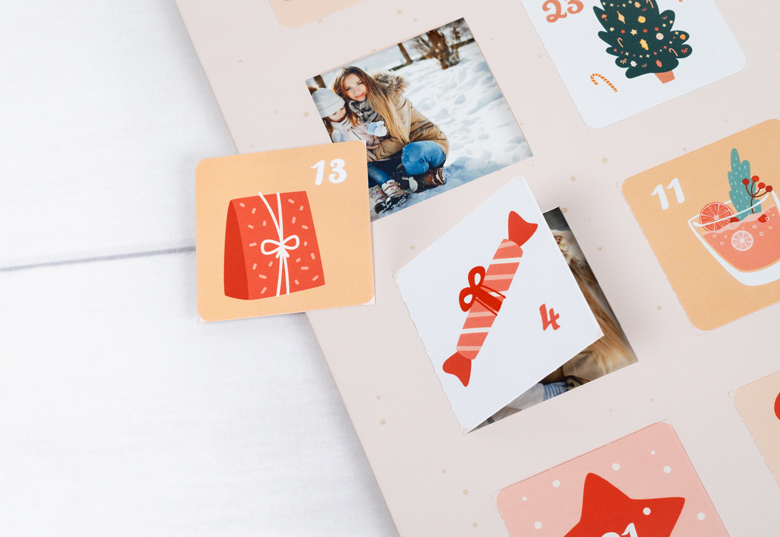 Personalised photo advent calendar with festive illustrations and numbered doors. One door is open, revealing a family photo.