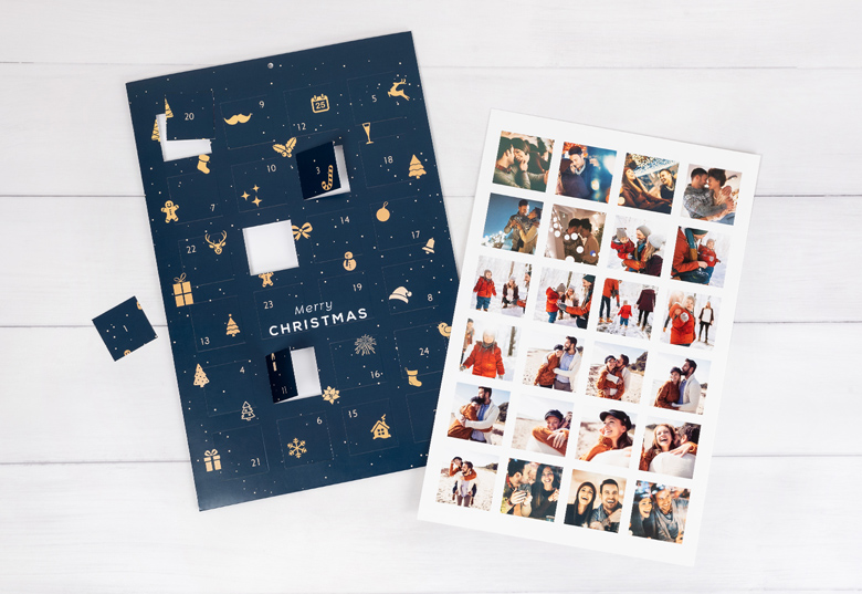 Navy blue photo advent calendar with gold festive symbols and customisable photo slots, accompanied by a sheet of personal photos.