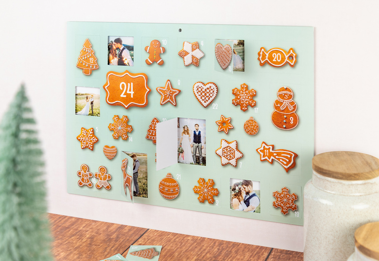 Personalised photo advent calendar with gingerbread-shaped decorations on a light green background. Each door reveals a custom photo.