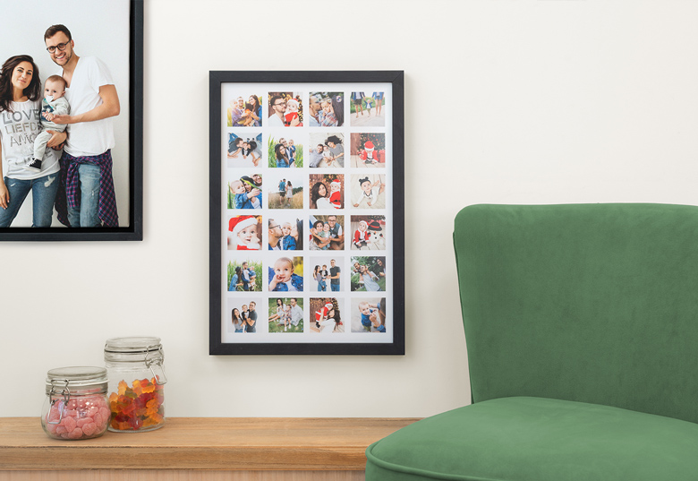 Personalised photo advent calendar with a black frame, featuring 24 colourful, customisable photo slots, displayed on a wall.