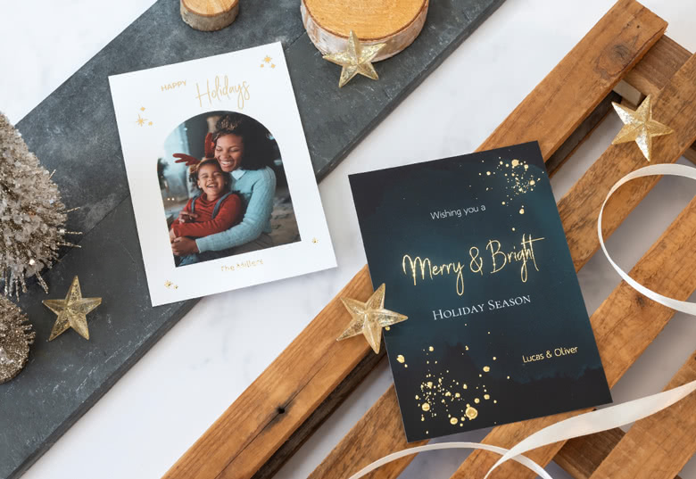 Gold Foil Photo Cards: One white card with a photo and "Happy Holidays" in gold, and one black card with gold "Merry & Bright" text.