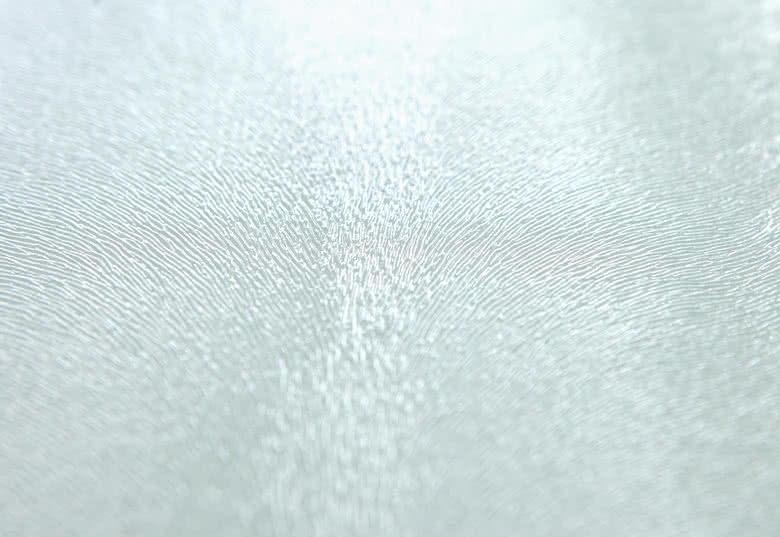 Close-up image of a textured, light-coloured cutting board with a subtle, intricate pattern, available for personalisation.