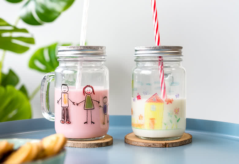 Glass drinking jar with lid and straw