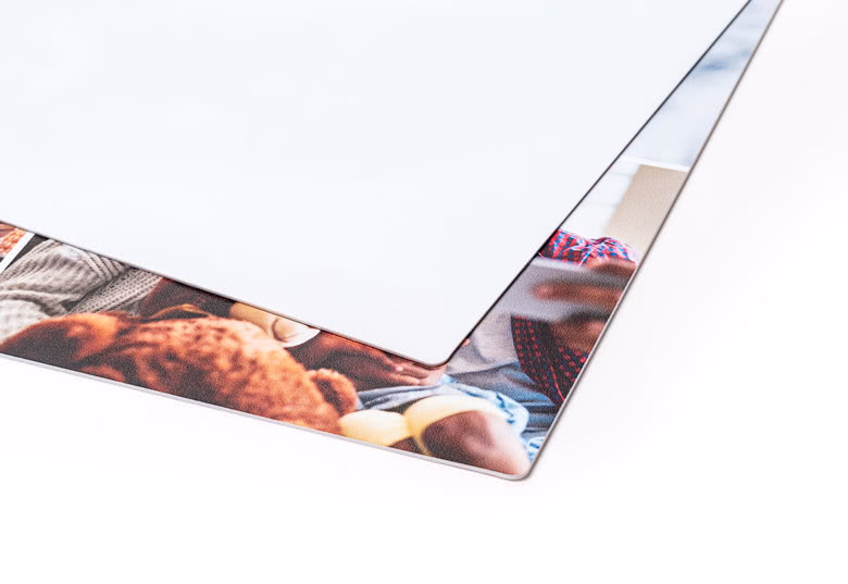 Material image of the back of a plastic placemat and a partial view of a personalised placemat with photo.