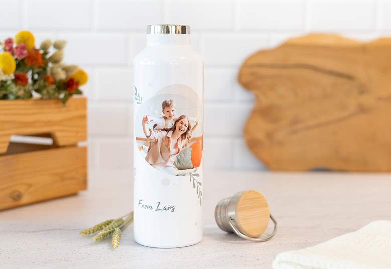 White thermos with a personalisable photo of a mother and child, featuring the text "From Lang" and a silver lid beside it.